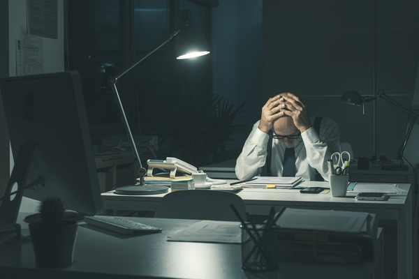 Stressed Business Executive Working Overtime